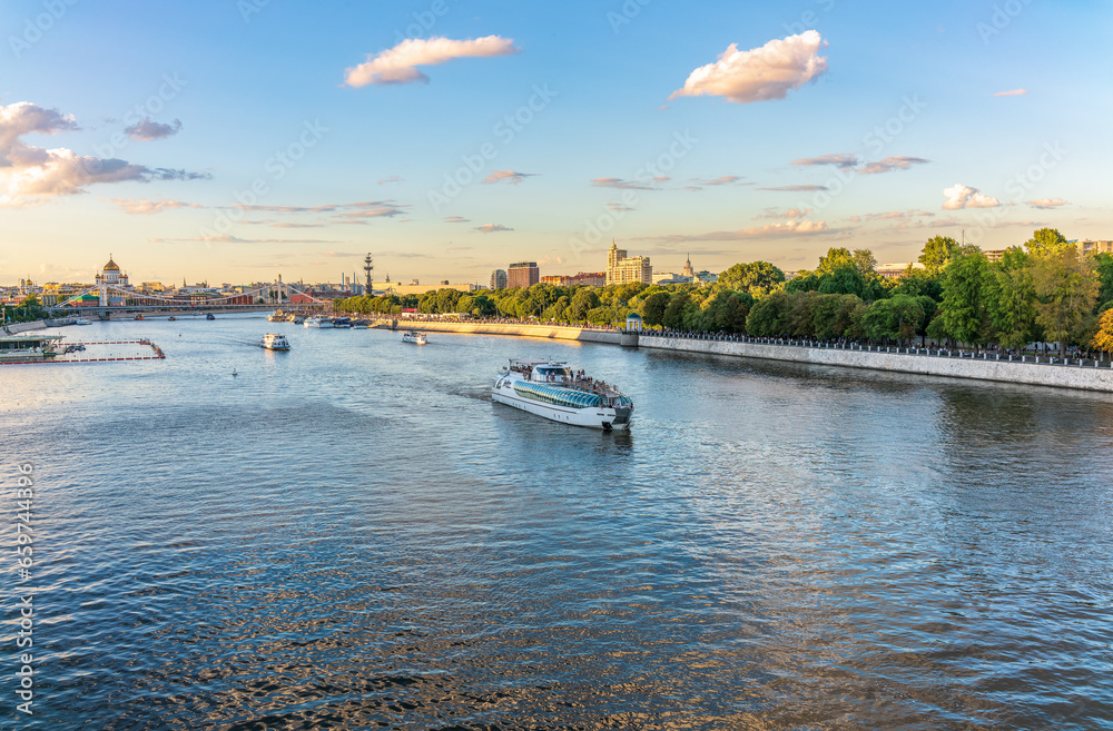 Cruise ship sails on the Moscow river in Moscow city center, popular place for walking. Cruise ship sails on the Moscow river in Moscow city center, popular place for walking.