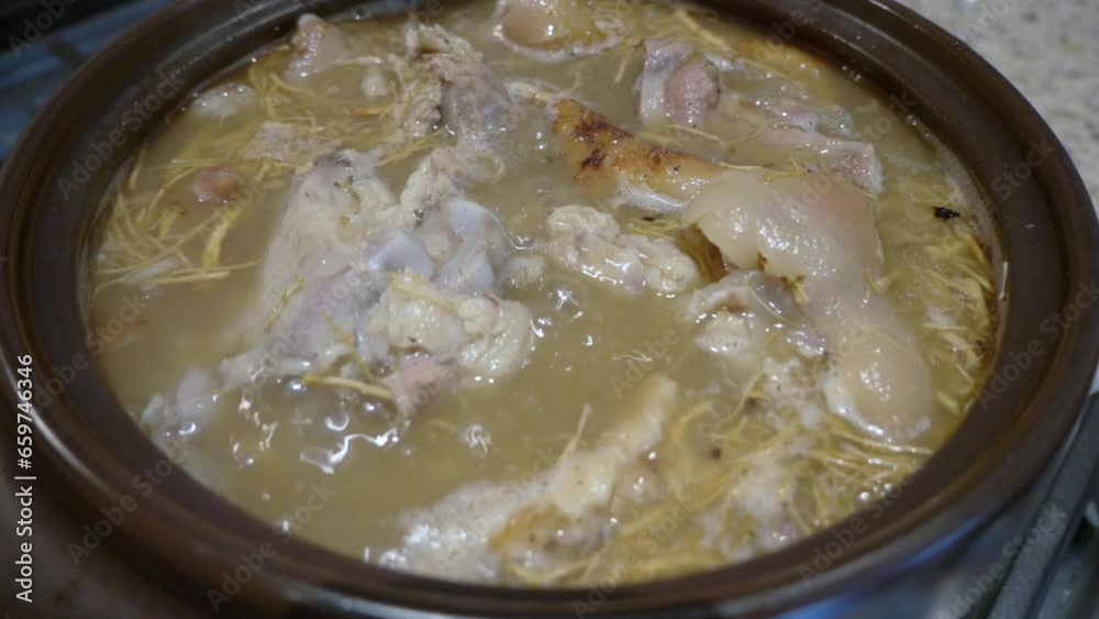 slow cooking ginseng pork bone soup boiling in clay pot zoom slow cooking ginseng pork bone soup boiling in clay pot zoom