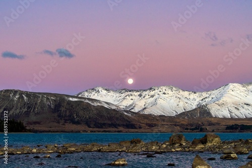 a super moon rises over Mount Dobson on the shores of Lake Tekapo on June 14th 2022 -  Lake Tekapo, Mackenzie Basin, New Zealand photo