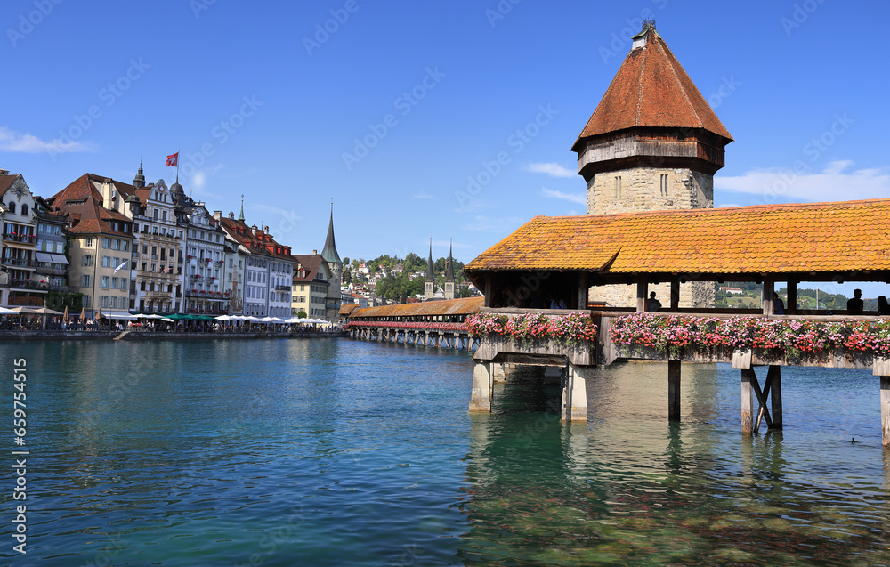 View towards Chapel Bridge (Kapellbruecke) together with the octagonal tall tower (Wasserturm) it is one of the Lucerne's most famous tourists’ attraction in Switzerland