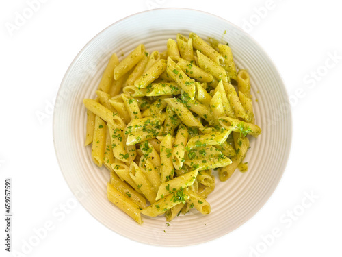 An isolated bowl of pesto pasta against a blank background - top view