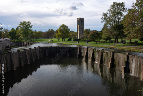 Tranquil scene in Frederick, MD: Carroll Creek dam, the famous carillon tower, and a vast green lawn offer a serene urban escape in Baker Park. photo