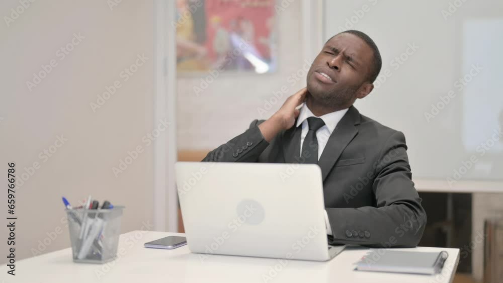 African Businessman with Neck Pain Working on Laptop in Office African Businessman with Neck Pain Working on Laptop in Office