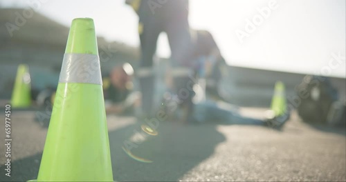 Emergency cone, road and paramedic at an accident for help, disaster management and evacuation. Teamwork, trauma and people or ambulance in the street for a death, injury or danger in traffic photo