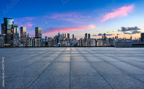 Empty square floors and city skyline with modern buildings scenery at sunset
