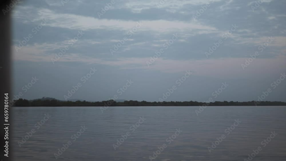 A tranquil scene of a forested lake or river from the perspective of a boat. Surrounded by lush greenery, the calm waters reflect the peace and beauty of the natural environment. A tranquil scene of a forested lake or river from the perspective of a boat. Surrounded by lush greenery, the calm waters reflect the peace and beauty of the natural environment.