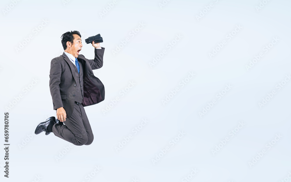 Fototapeta premium 双眼鏡を持ってジャンプする中年ビジネスマン（切り抜き背景透過PNGも販売しております。作成者リンクから「PNG」で検索してください）