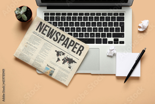 Laptop with newspaper, pen ...