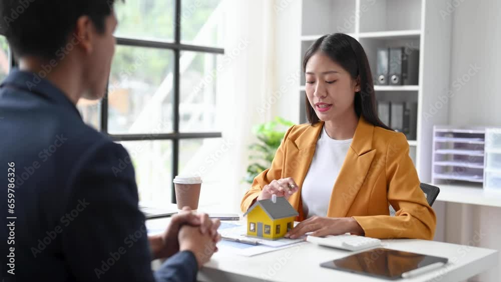Real estate broker agent presenting and consult to customer to decision making sign insurance form agreement, home model, concerning mortgage loan offer . Real estate broker agent presenting and consult to customer to decision making sign insurance form agreement, home model, concerning mortgage loan offer .