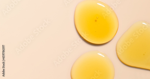 round drops gel serum on beige background