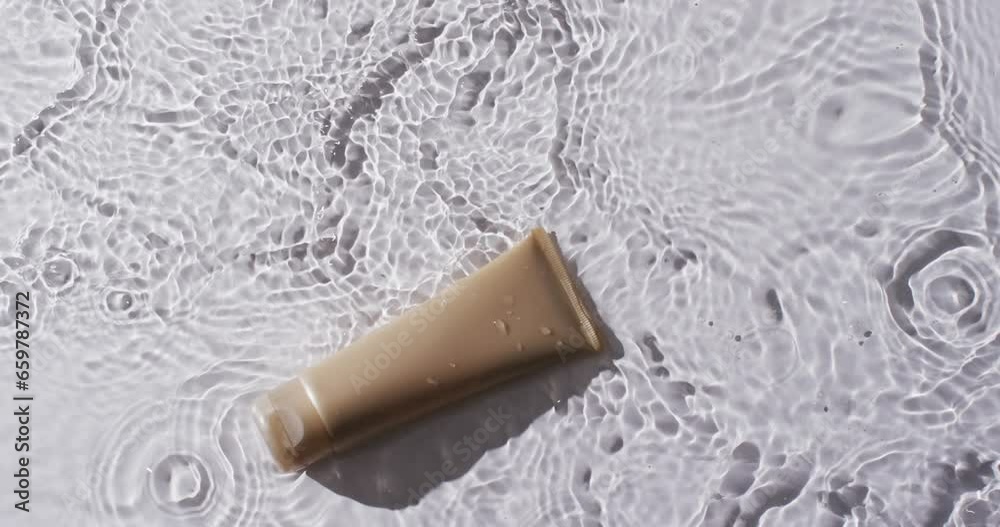 Video of beauty product tube in water with copy space on white background Video of beauty product tube in water with copy space on white background