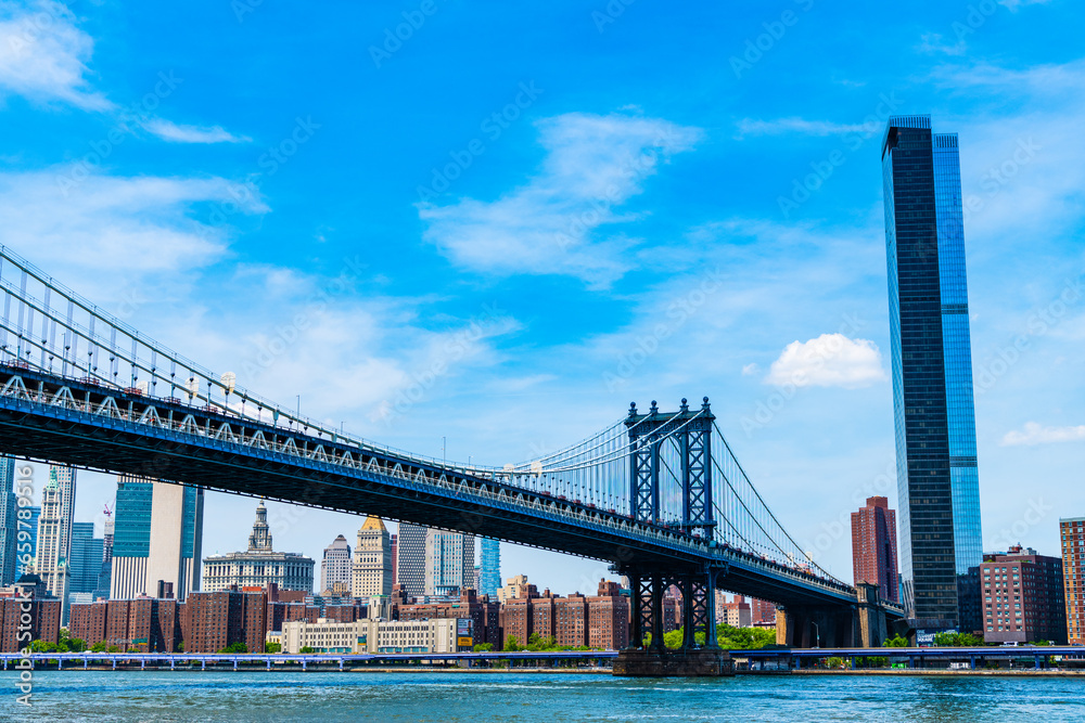 Fototapeta premium New York City, USA - May 12, 2023: Crossing east river. manhattan bridge in new york. architecture of historic bridge in manhattan.