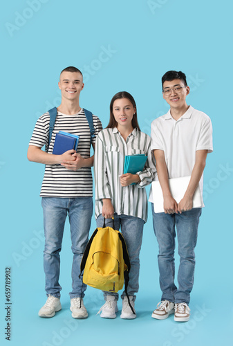 Happy students with noteboo...