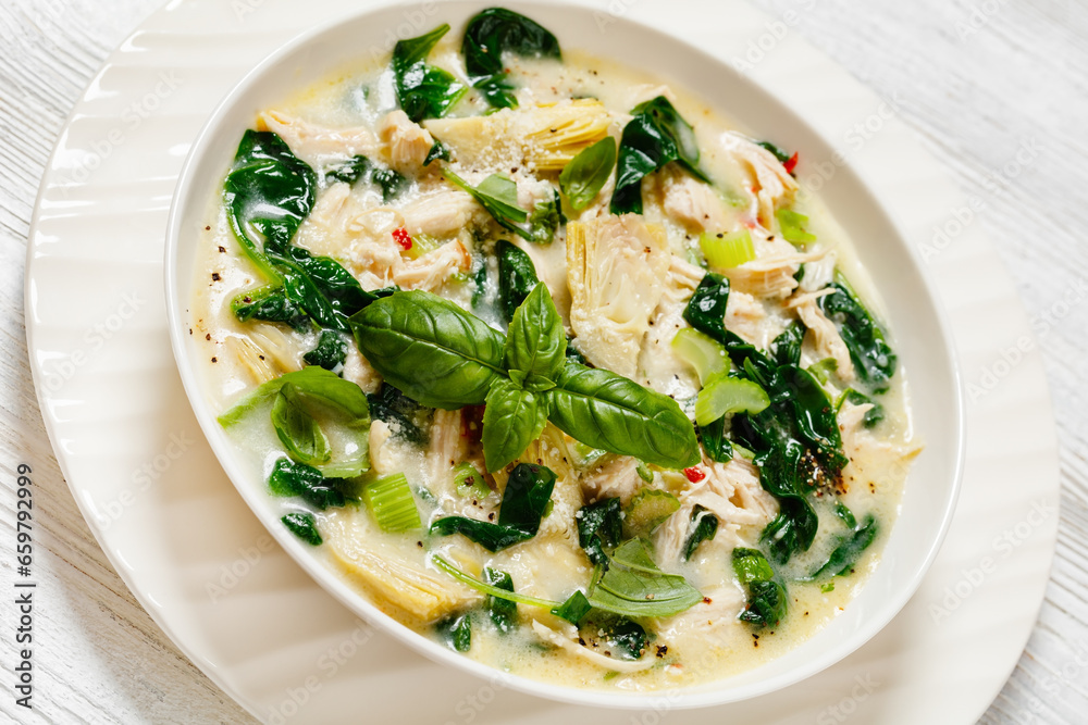 chicken spinach artichoke creamy soup in a bowl chicken spinach artichoke creamy soup in a bowl