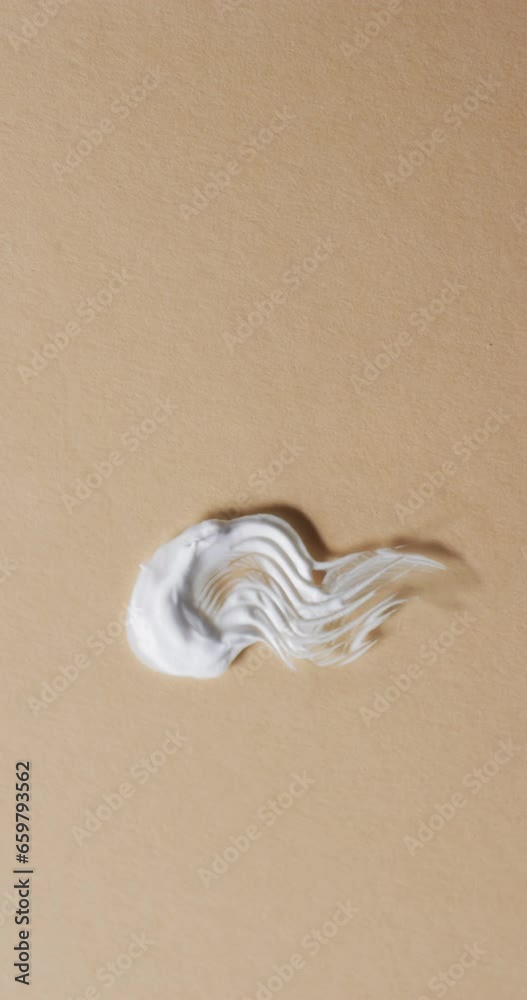 Vertical video of cream smudges with copy space on yellow background Vertical video of cream smudges with copy space on yellow background