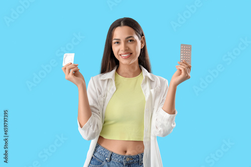 Young woman with condom and...
