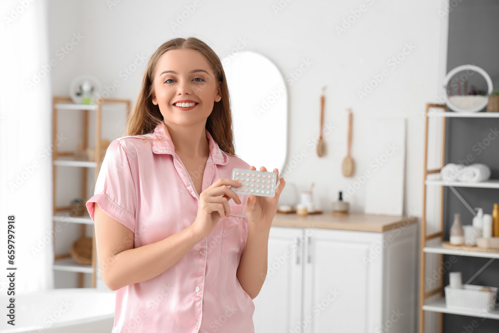 Young woman with contraceptive pills in bathroom Young woman with contraceptive pills in bathroom