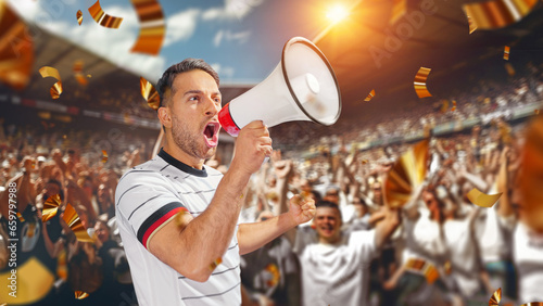 soccer fan with megaphone in hand in soccer stadium celebrating the game. photo