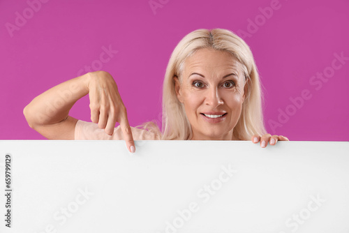 Mature woman pointing at bl...