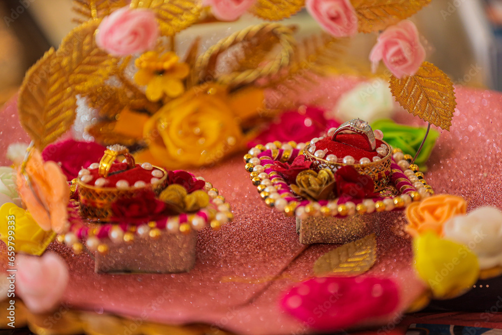Wedding rings in wedding ceremony, Indian wedding rings in an open box on traditional style garland. 
