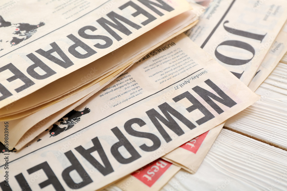 Fototapeta premium Morning newspapers on white wooden background