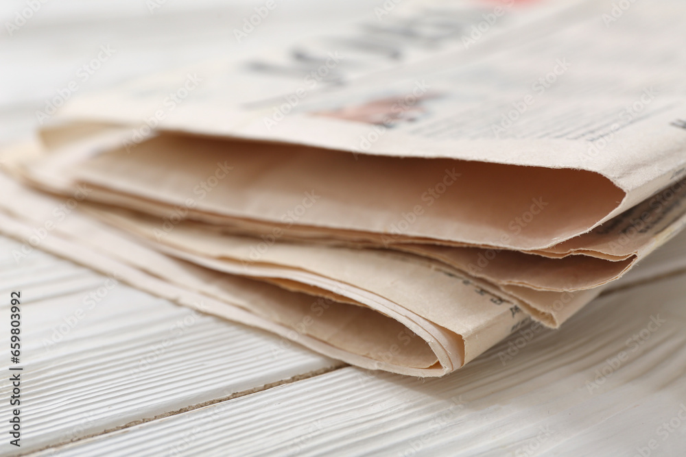 Morning newspapers on white wooden background Morning newspapers on white wooden background