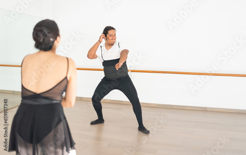 ballet dancers having fun in class in a practice rest they are laughing and dancing pop music