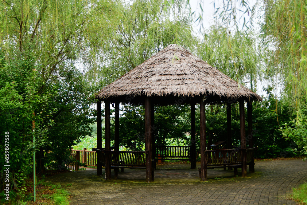 Photo of a wooden gazebo in the garden Photo of a wooden gazebo in the garden