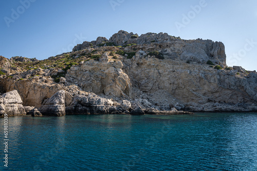 Majestic Rock Formations of Rhodes: A sea-level view of the stunning cliffs and geological wonders along the island's coastline, where the Mediterranean's blue embraces Grecian landscapes.