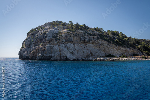 Stunning Anthony Quinn Bay Beach and Rock Formations of Rhodes: A sea-level panoramic view of the island's diverse coastline, showcasing sandy retreats and towering cliffs, epitomizing Grecian beauty.