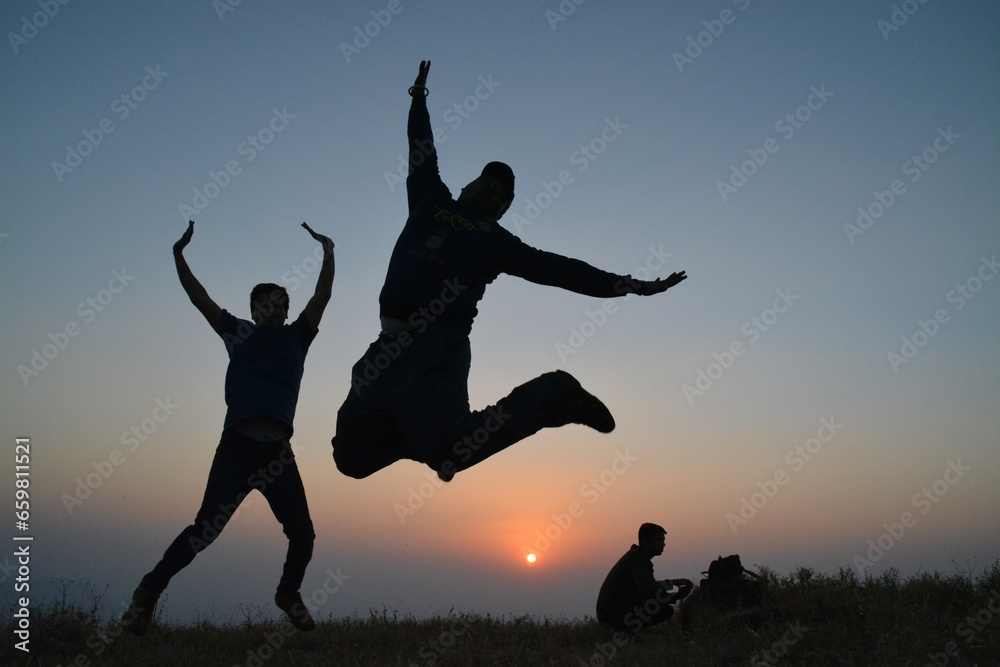 silhouette of a couple jumping silhouette of a couple jumping