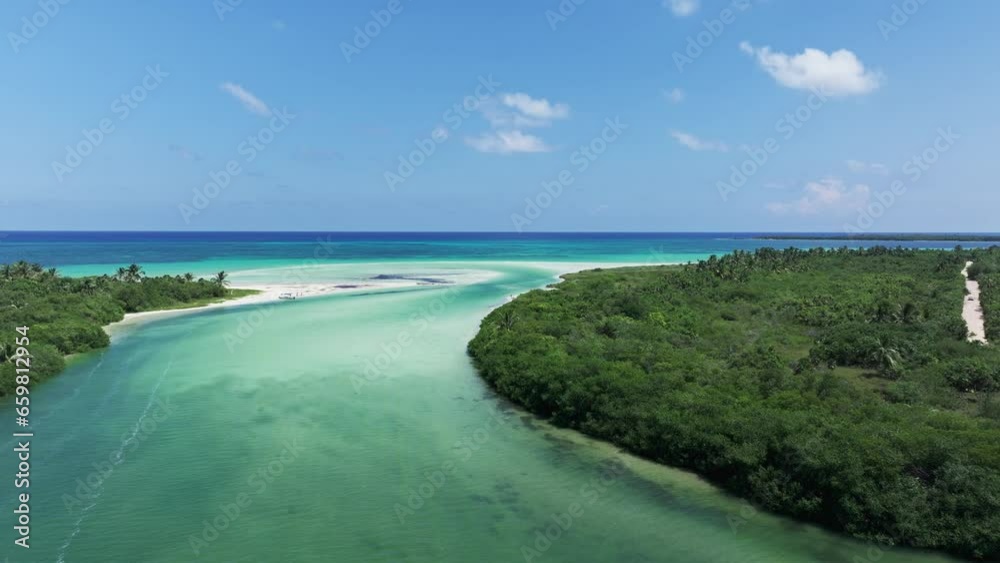 Drone dolly above boardwalk over sandy river estuary and channel leading to blue ocean water, Tulum Mexico Drone dolly above boardwalk over sandy river estuary and channel leading to blue ocean water, Tulum Mexico