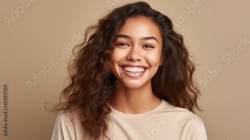 In a candid moment, a teenage girl's captivating smile steals the spotlight against a light studio setting.