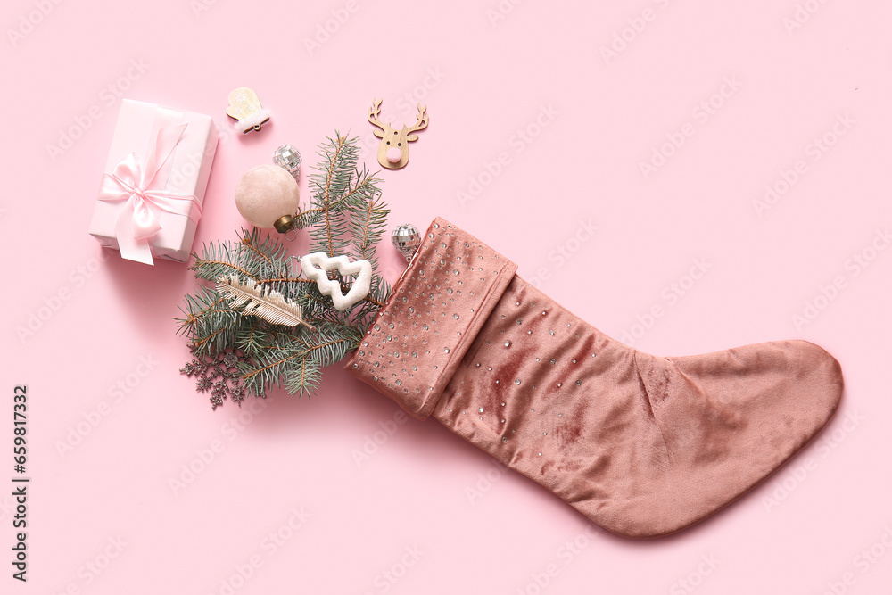 Beautiful Christmas sock with gift box and decorations on pink background Beautiful Christmas sock with gift box and decorations on pink background