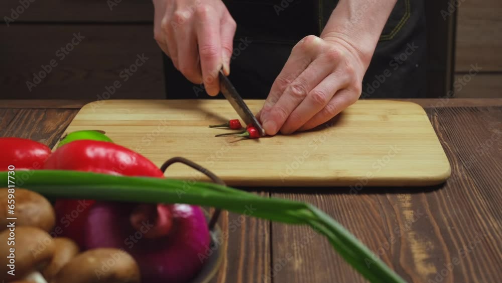 Cutting fresh hot chilli pepper close up