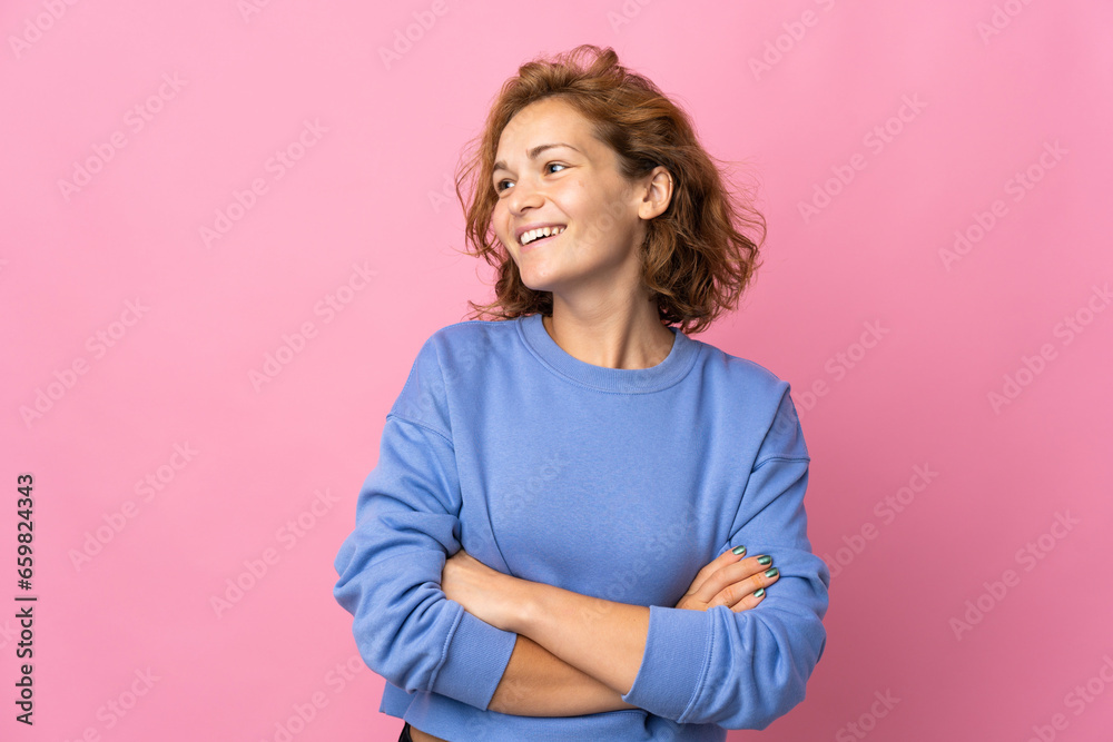 Fototapeta premium Young Georgian woman isolated on pink background happy and smiling