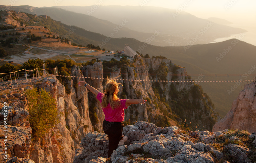 Naklejka premium Back view of the plus size woman walks in the mountain. The gil admires beautiful views of landscape. Travel and tourism. Hiking.