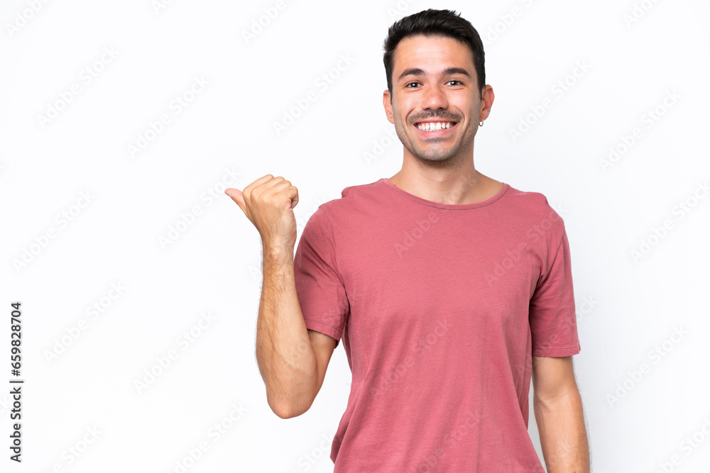 Young handsome man over isolated white background pointing to the side to present a product Young handsome man over isolated white background pointing to the side to present a product