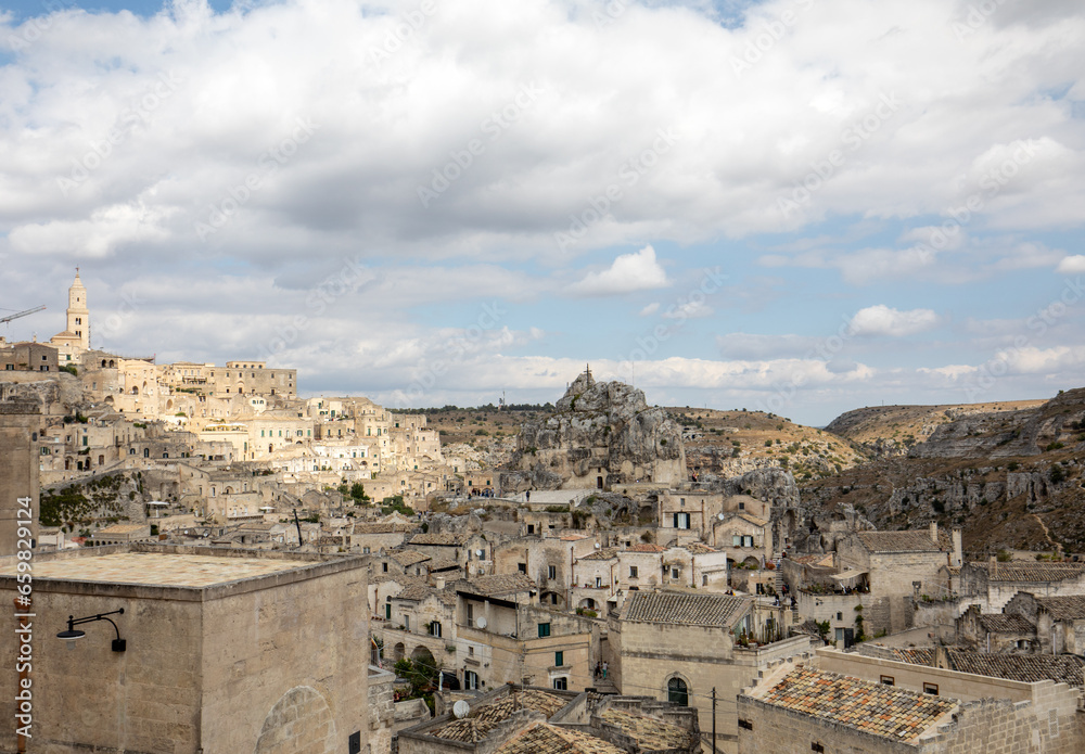 View of the Sassi di Matera a historic district in the city of Matera, well-known for their ancient cave dwellings. Basilicata. Italy View of the Sassi di Matera a historic district in the city of Matera, well-known for their ancient cave dwellings. Basilicata. Italy