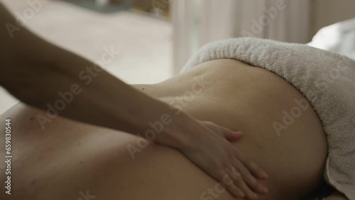 Professional massage on female back with dowager's hump photo