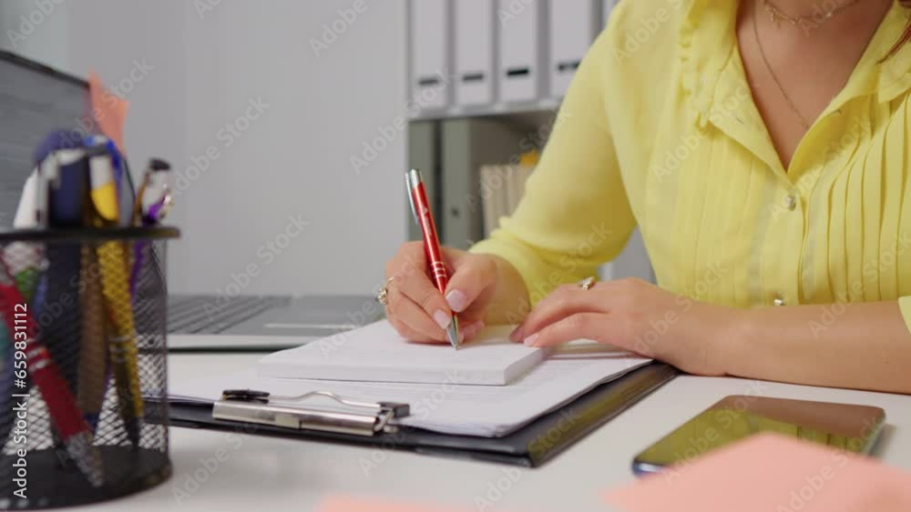 Woman hand taking notes of her new ideas working remotely. Euphoric motivated lady accomplishing tasks from fome office. Woman hand taking notes of her new ideas working remotely. Euphoric motivated lady accomplishing tasks from fome office.
