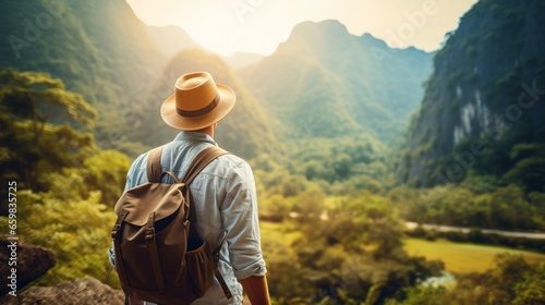 handsome young man tourist traveler carries his backpack with mountains on background © id512