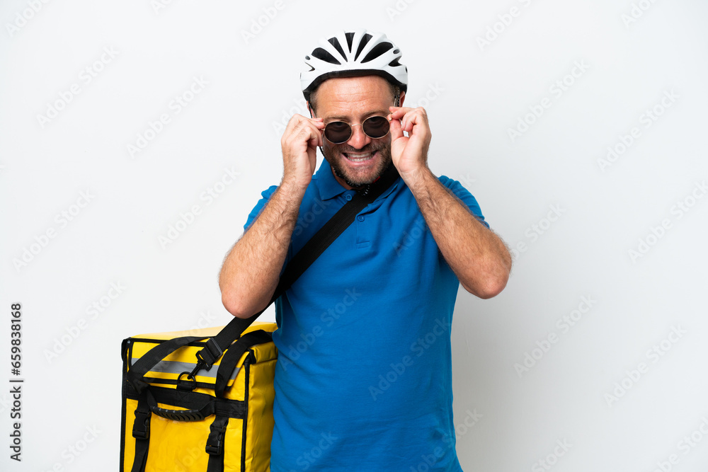 Middle age caucasian man with thermal backpack isolated on white background with glasses and surprised Middle age caucasian man with thermal backpack isolated on white background with glasses and surprised