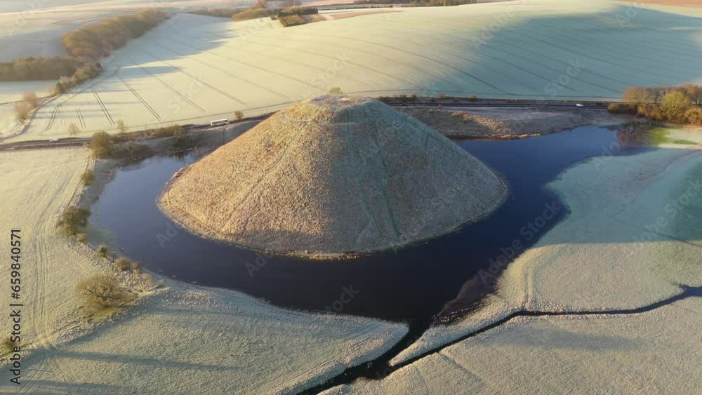 Aerial of Neolithic Silbury Hill, UNESCO World Heritage Site, on a ...