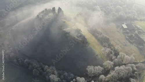 Aerial of Corfe Castle at dawn on a chilly frosty winter morning, Corfe, Dorset, England photo