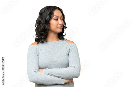 Young Argentinian woman over isolated background looking to the side