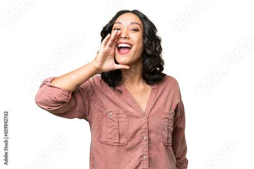 Young Argentinian woman over isolated background shouting with mouth wide open