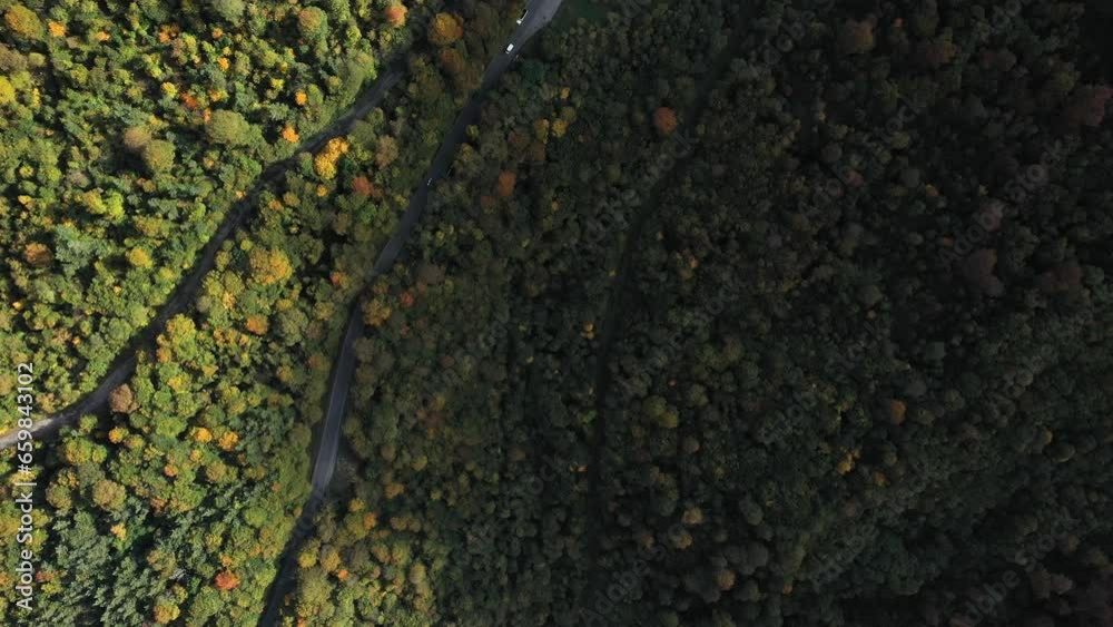 Aerial view on mountains covered with green trees and blue skies and clouds on the background Aerial view on mountains covered with green trees and blue skies and clouds on the background