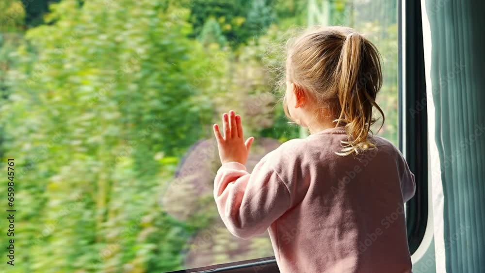Little girl looking out train window outside, during moving. Traveling by railway, Europe