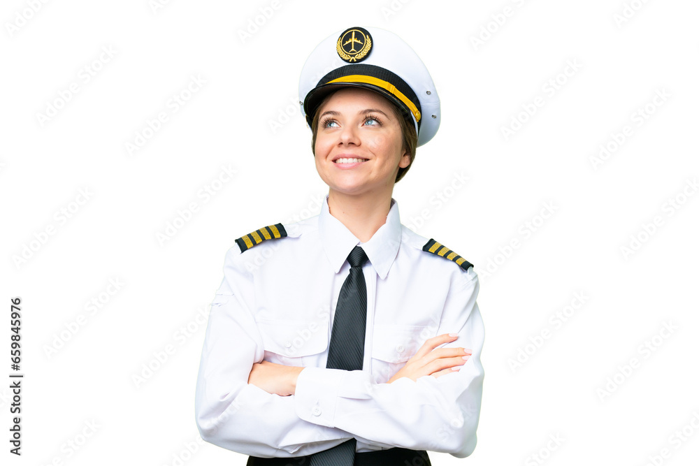 Airplane pilot woman over isolated chroma key background looking up while smiling Airplane pilot woman over isolated chroma key background looking up while smiling